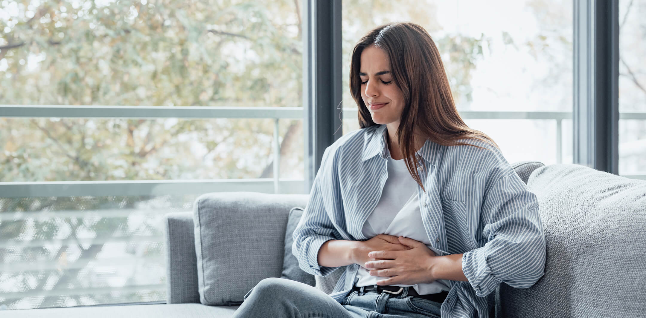 sick-young-woman-in-pain-holding-belly-stomach-fee-2025-03-08-20-23-41-utc (1)
